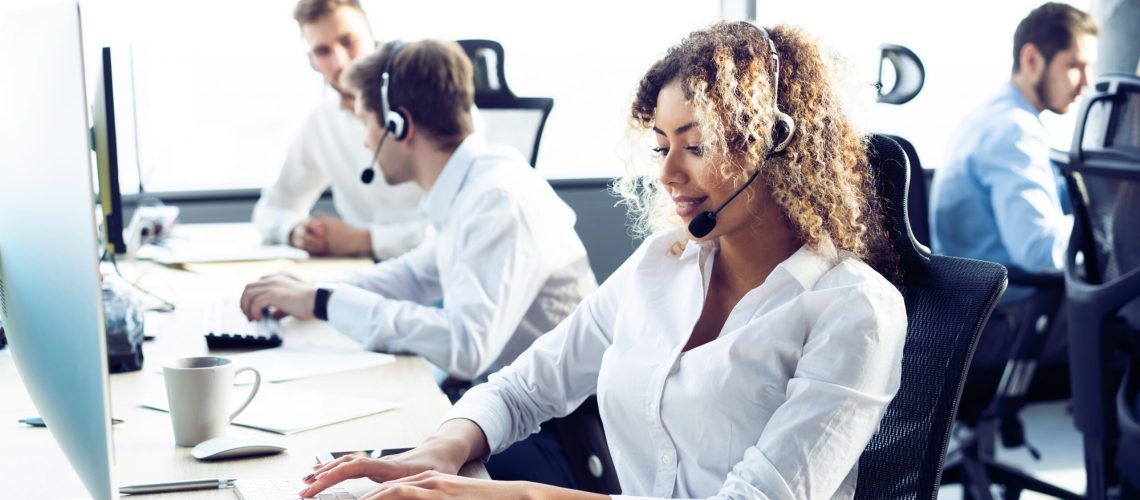 How can I help you? Female customer support operator with headset and smiling